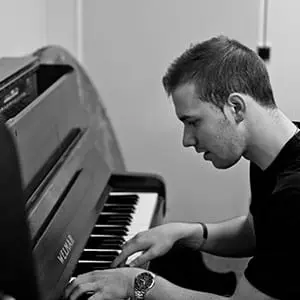 Piano coach Jack Marshall playing piano